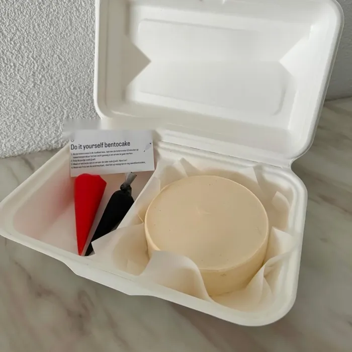 İki bölmeli doğa dostu bento kutusunda mini pasta ve kendin süsle krema torbaları